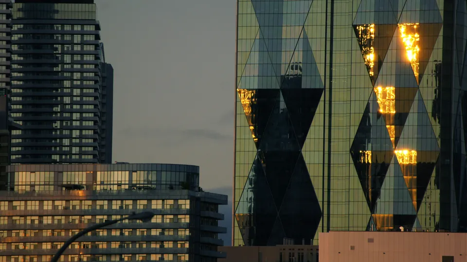 Glass office towers in downtown Toronto on a clear day.